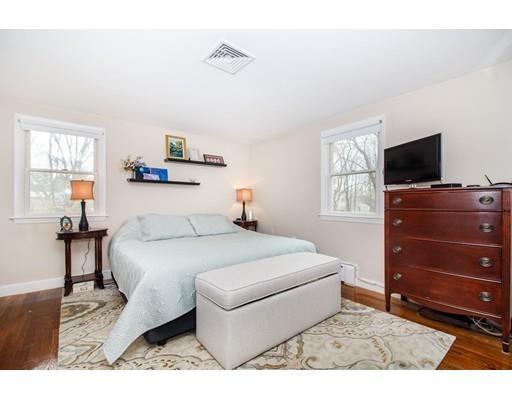 9 Sandrick Road Belmont, MA 02478 - Photo 12 of 21 a bedroom with a bed and a flat tv screen on dresser