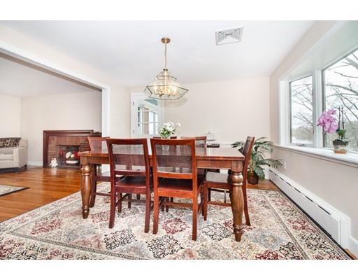 9 Sandrick Road Belmont, MA 02478 - Photo 5 of 21 a dining room with wooden floor a chandelier a wooden table and chairs