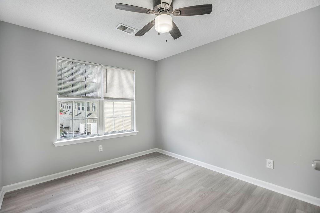 6947 Gallant Circle Southeast, Unit 10 Mableton, GA 30126 - Photo 20 of 26 an empty room with chandelier fan and windows