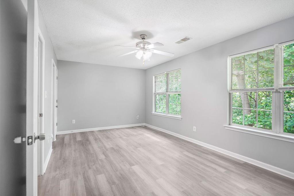 6947 Gallant Circle Southeast, Unit 10 Mableton, GA 30126 - Photo 2 of 26 wooden floor in an empty room with a window
