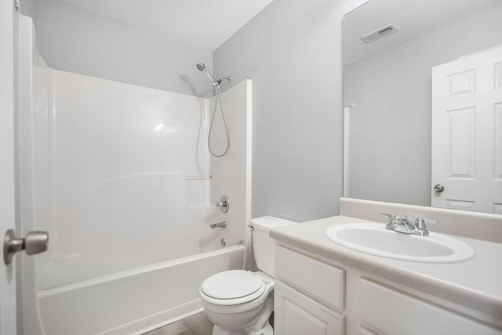 6947 Gallant Circle Southeast, Unit 10 Mableton, GA 30126 - Photo 5 of 26 a bathroom with a sink toilet vanity and shower