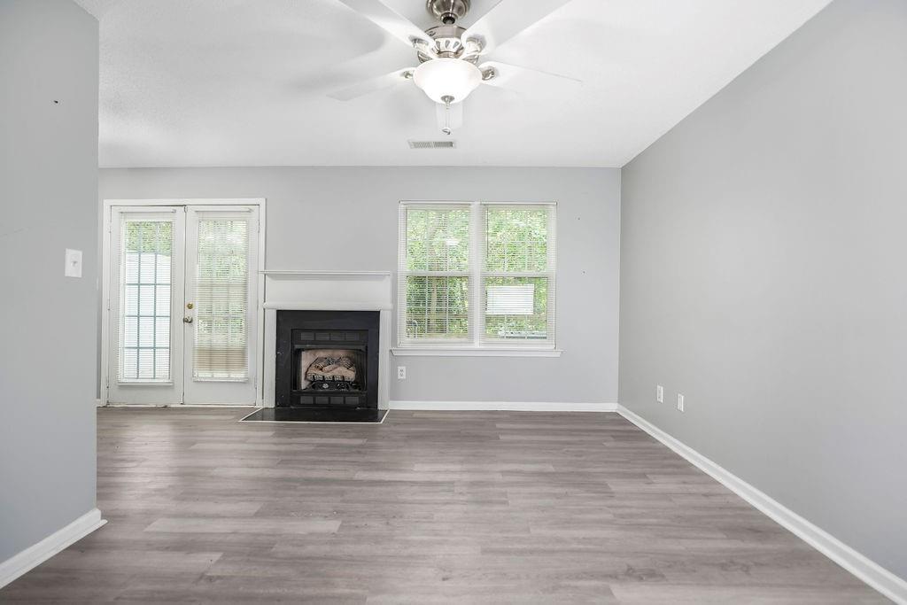 6947 Gallant Circle Southeast, Unit 10 Mableton, GA 30126 - Photo 8 of 26 an empty room with windows and a fireplace