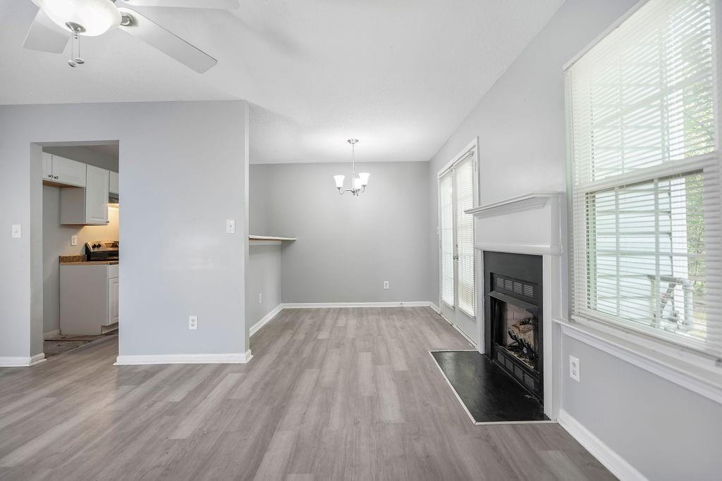6947 Gallant Circle Southeast, Unit 10 Mableton, GA 30126 - Photo 10 of 26 an empty room with wooden floor a fireplace and windows