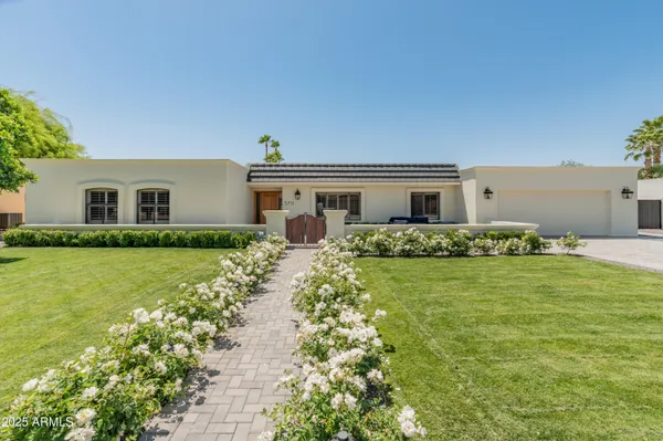 a view of a backyard with plants and patio