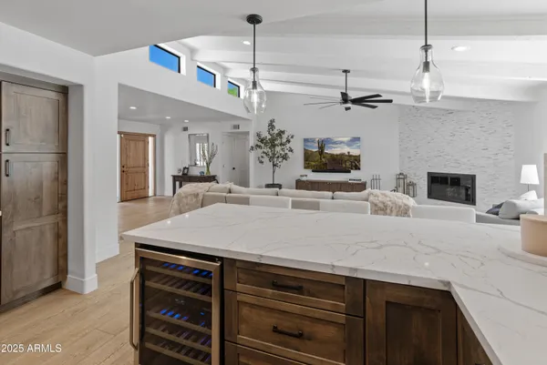 a kitchen with stainless steel appliances granite countertop a kitchen island a stove a sink and a refrigerator