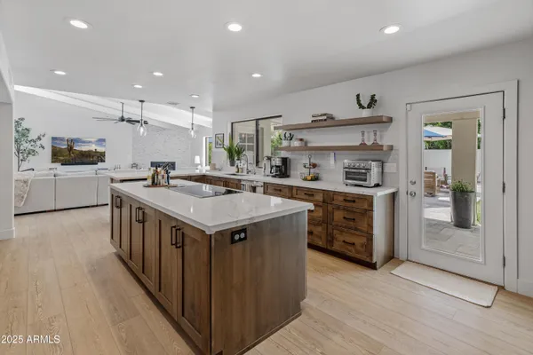 a kitchen with a stove a sink a refrigerator and a oven