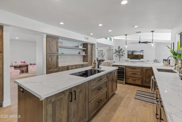 a kitchen with stainless steel appliances granite countertop sink stove top oven and cabinets