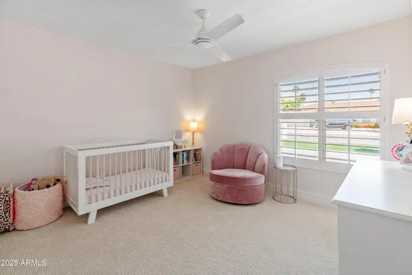 a spacious bedroom with a bed and a dresser