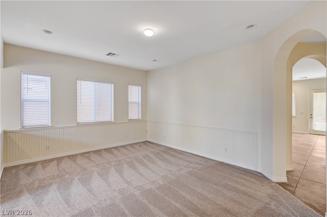 6761 Clay TABLET Street Las Vegas, NV 89149 - Photo 10 of 73 Soft carpeting underfoot and classic wainscoting details create a welcoming, versatile living space.