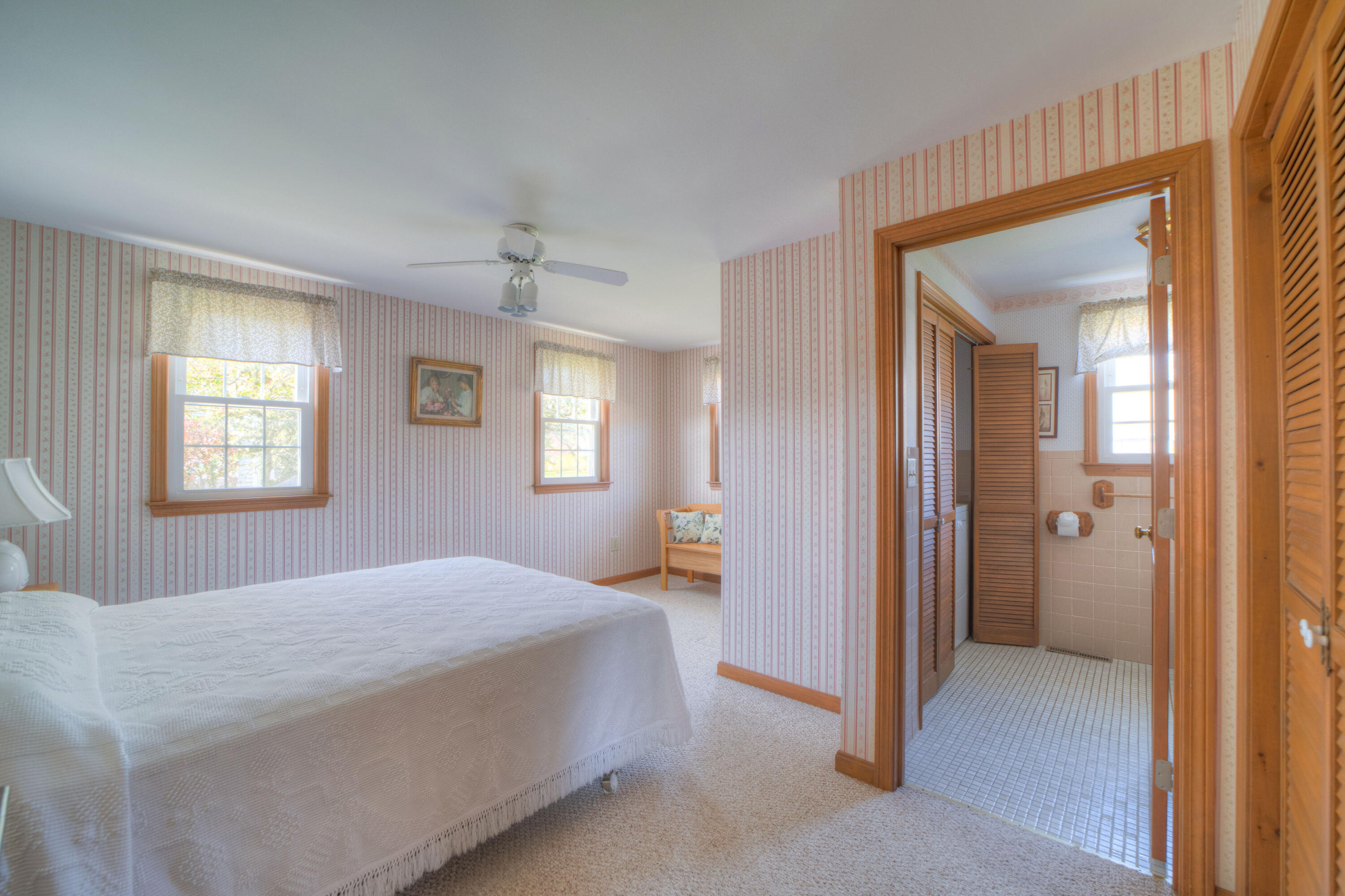 132 Indian Pond Road West Dennis, MA 02670 - Photo 16 of 21 a bedroom with a bed and a chandelier