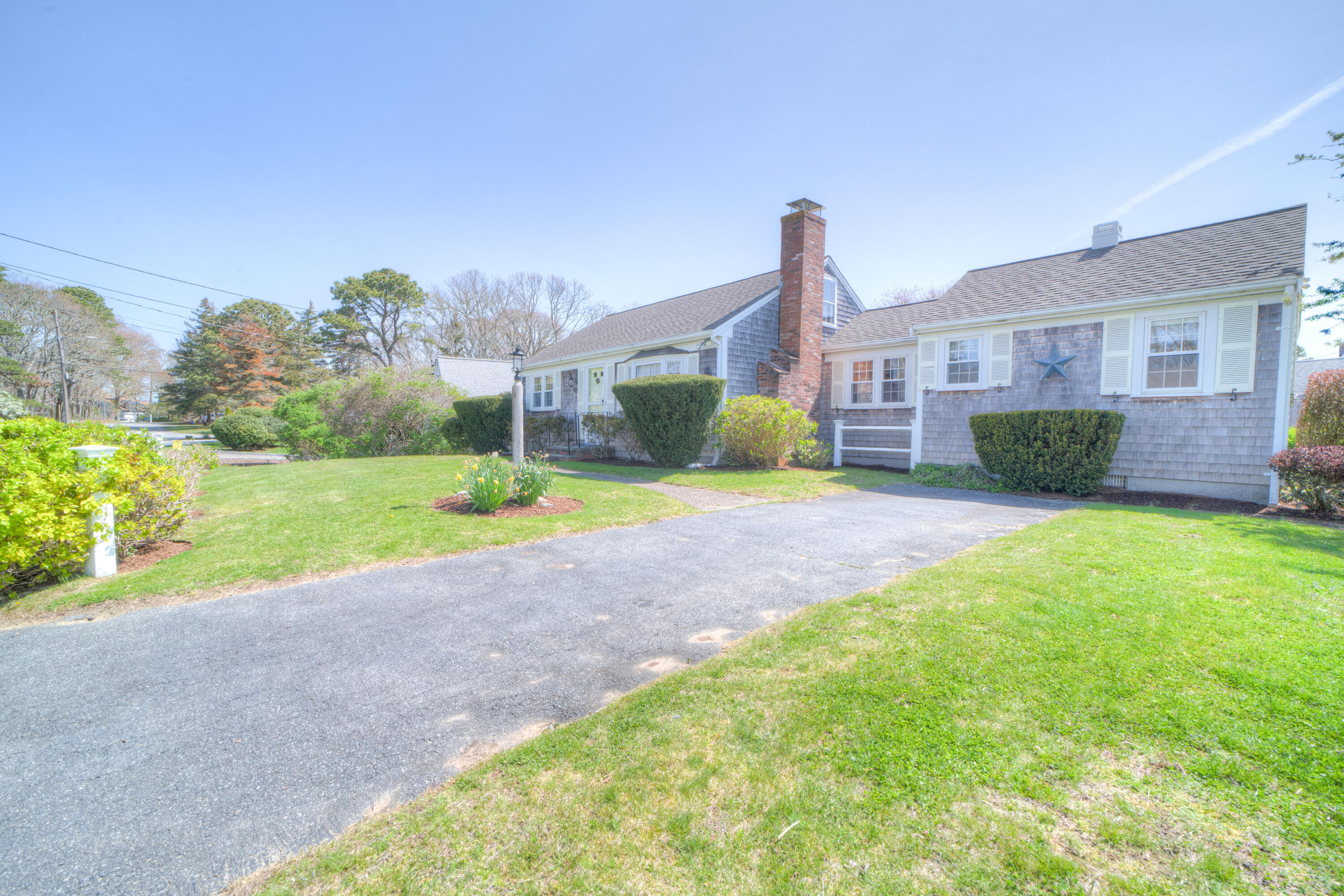 132 Indian Pond Road West Dennis, MA 02670 - Photo 2 of 21 a view of a house with a yard and a large tree
