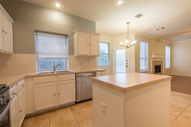 a kitchen with stainless steel appliances granite countertop a sink a stove and a refrigerator