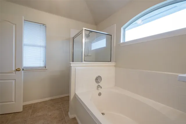 a bathroom with a bathtub and shower