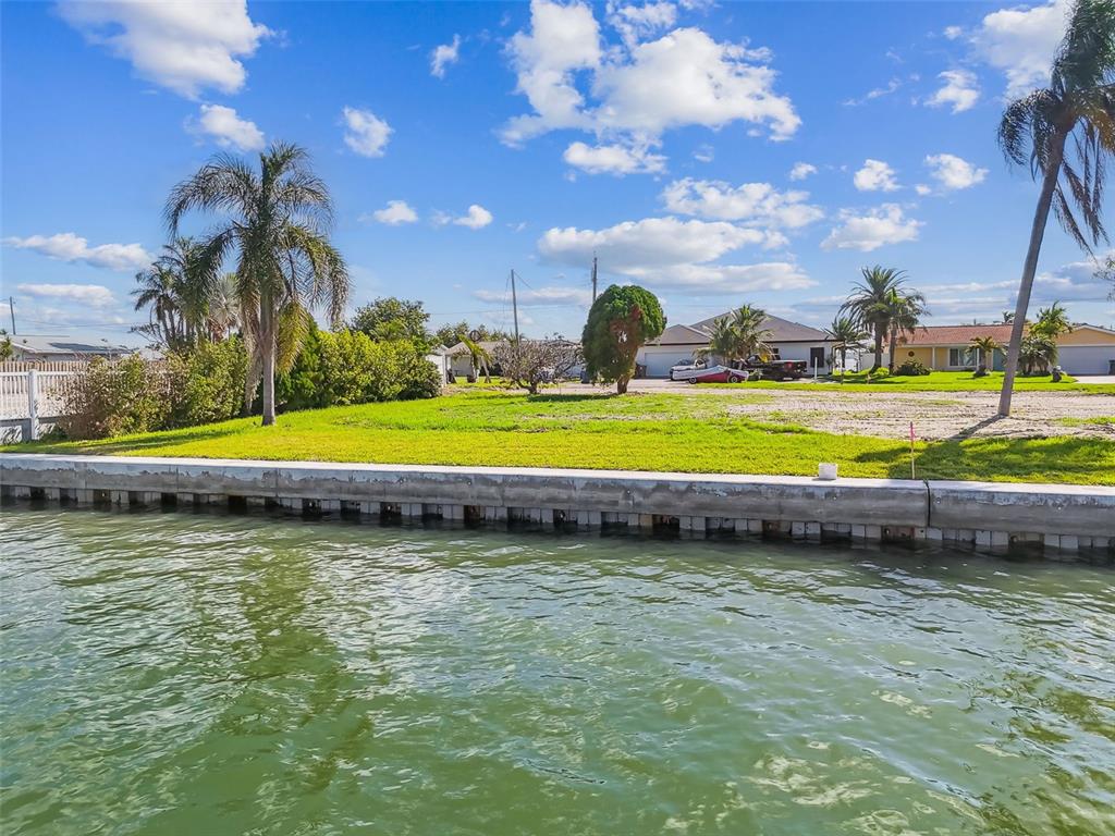 570 Johns Pass Avenue Madeira Beach, FL 33708 - Photo 8 of 39 a view of a swimming pool with an outdoor space and seating area