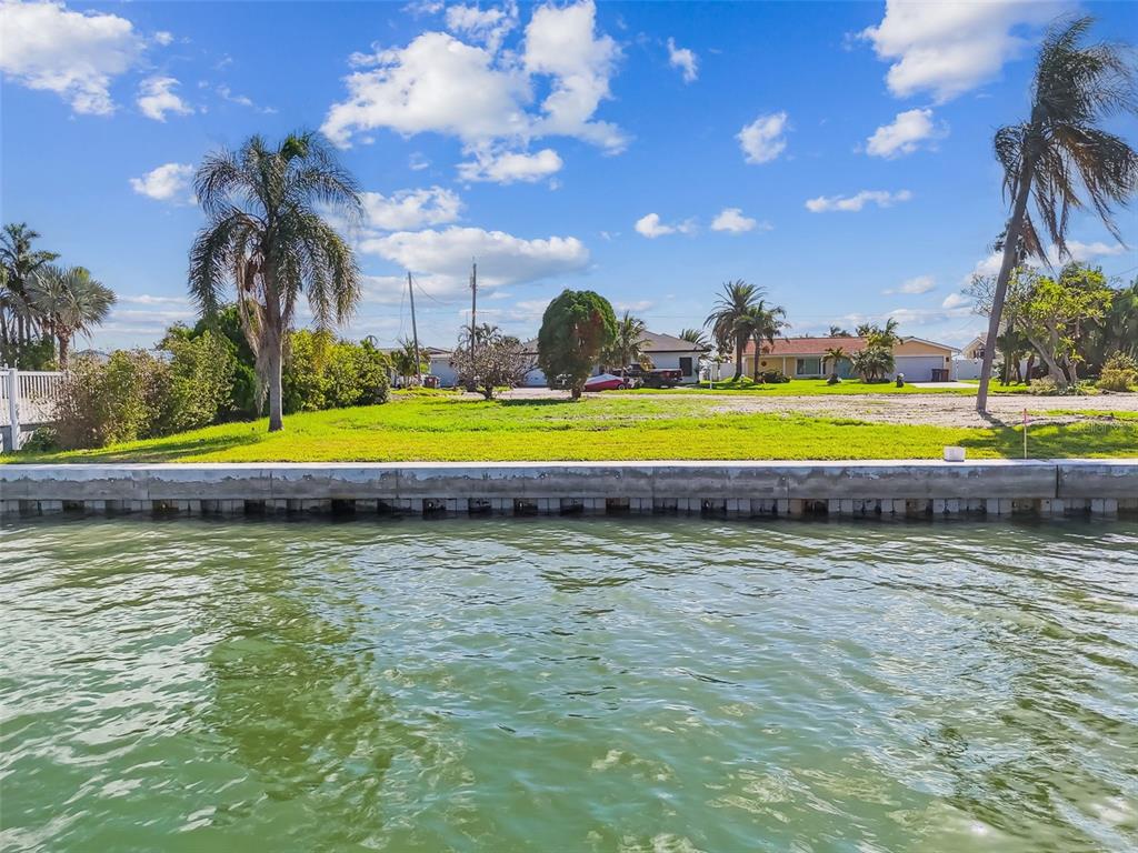 570 Johns Pass Avenue Madeira Beach, FL 33708 - Photo 9 of 39 a front view of a house with a yard and palm trees