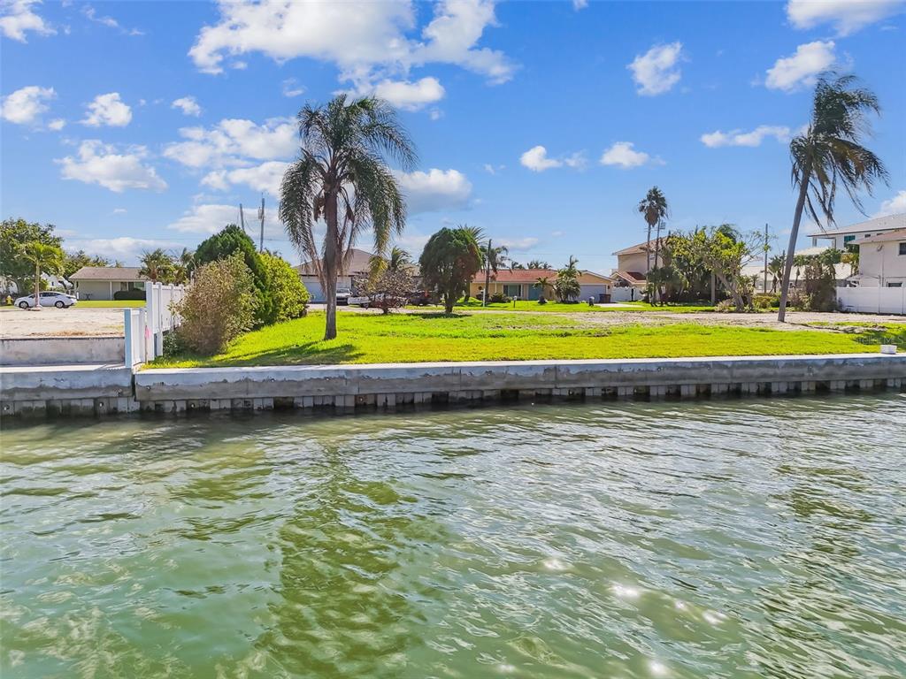 570 Johns Pass Avenue Madeira Beach, FL 33708 - Photo 10 of 39 a view of a swimming pool with an outdoor space and seating area