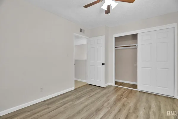 a bathroom with a granite countertop sink a light fixture and a mirror