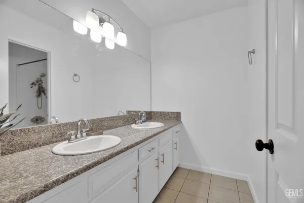 a bathroom with a shower and mirror