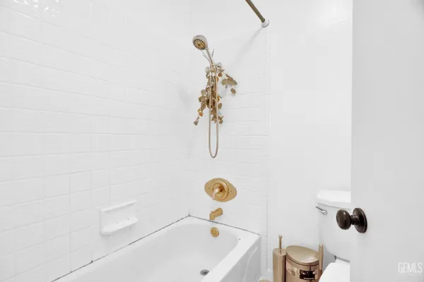 a spacious bedroom with a bed and a window