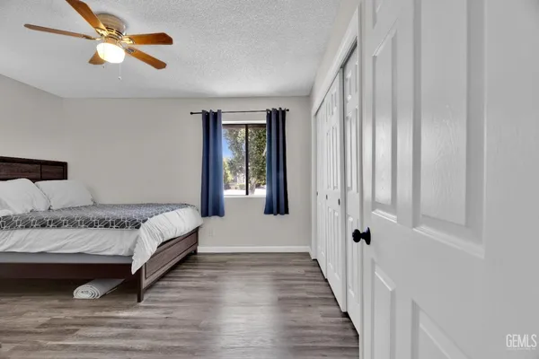 a bedroom with a bed and a chair