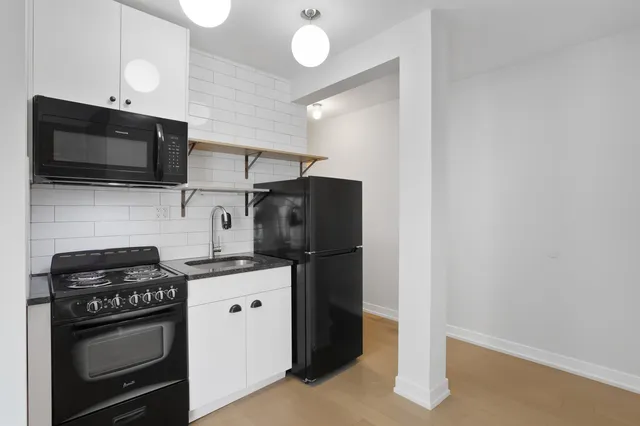 a kitchen with stainless steel appliances granite countertop a stove and a microwave