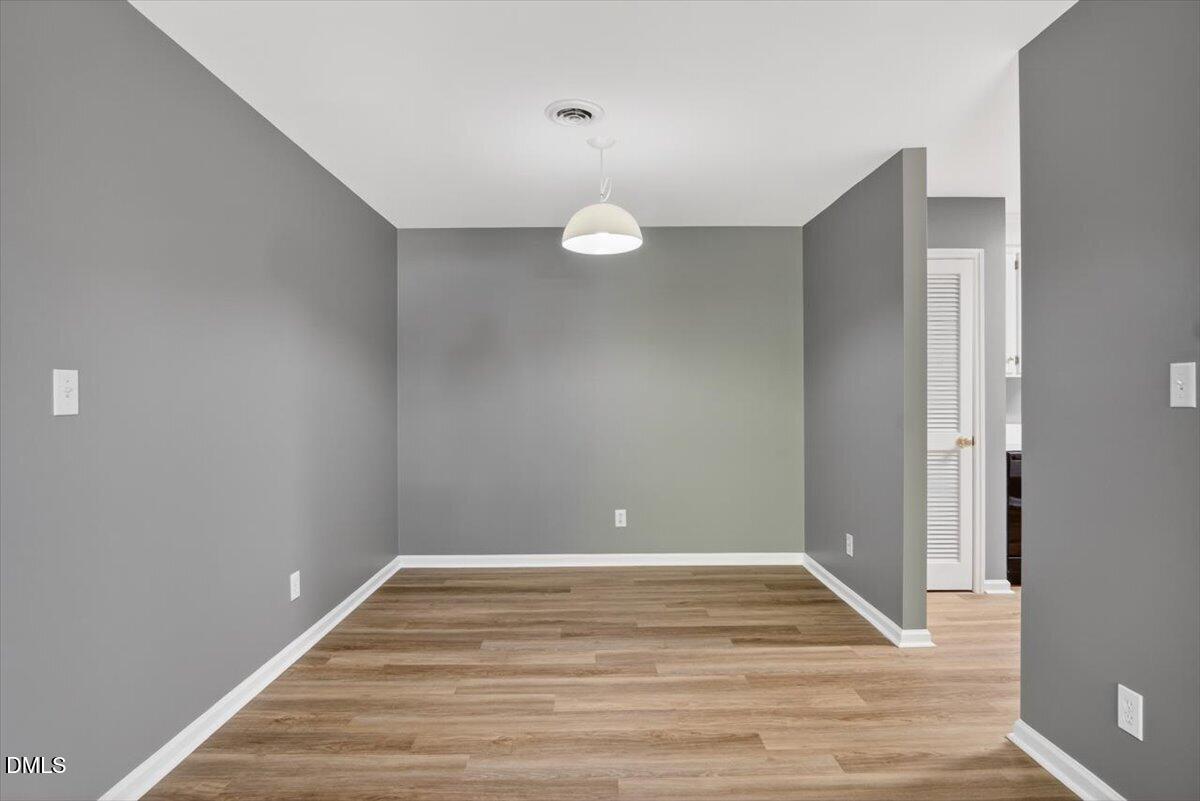 1630 Oxford Road, Unit F Henderson, NC 27536 - Photo 8 of 33 a view of a room with wooden floor and white walls