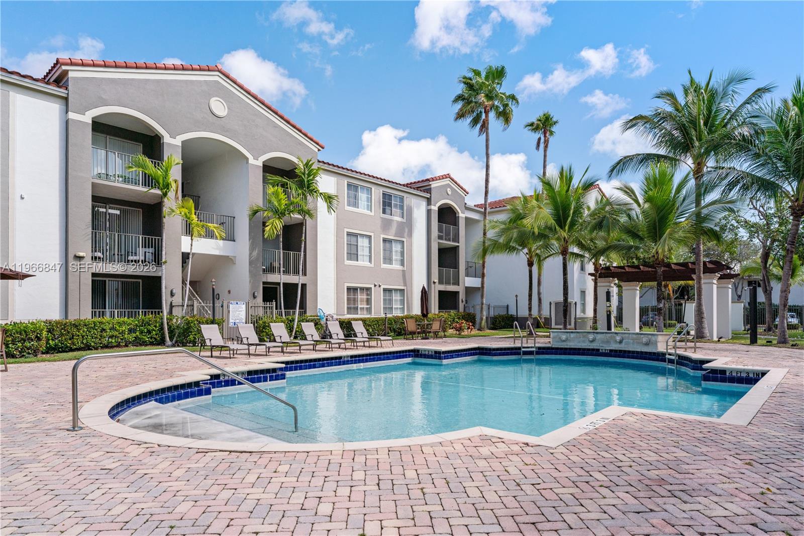 6851 Southwest 44th Street, Unit 307 Miami, FL 33155 - Photo 9 of 17 a view of a house with swimming pool and a yard