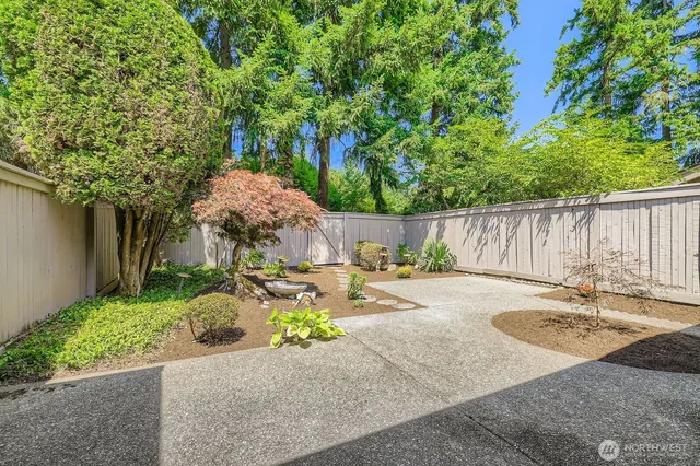 a backyard of a house with table and chairs