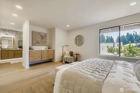 a bedroom with a bed and a large window