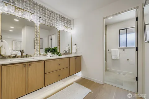 a spacious bathroom with a granite countertop sink mirror and shower