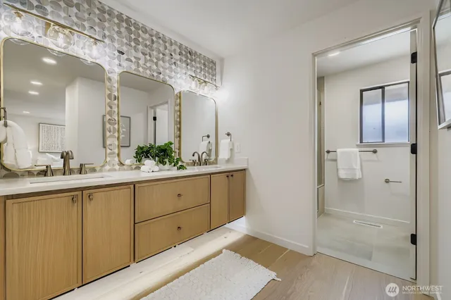 a spacious bathroom with a granite countertop sink mirror and shower