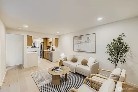 a living room with furniture and a painting on the wall