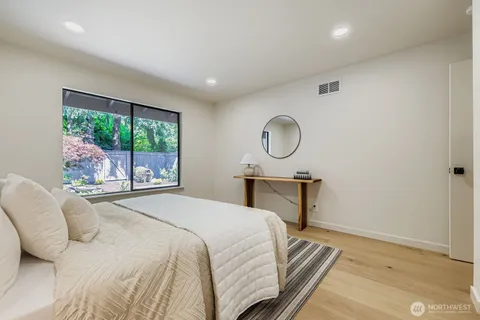 a bedroom with a bed a window and walk in closet