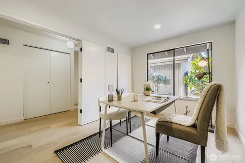 a view of a dining room with furniture and a window