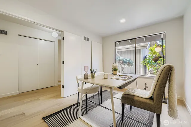 a view of a dining room with furniture and a window