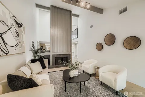 a living room with furniture potted plant and a fireplace