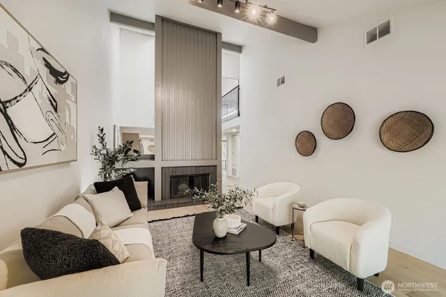 a living room with furniture potted plant and a fireplace