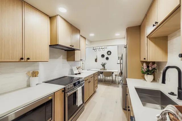 a kitchen with a sink stove and cabinets