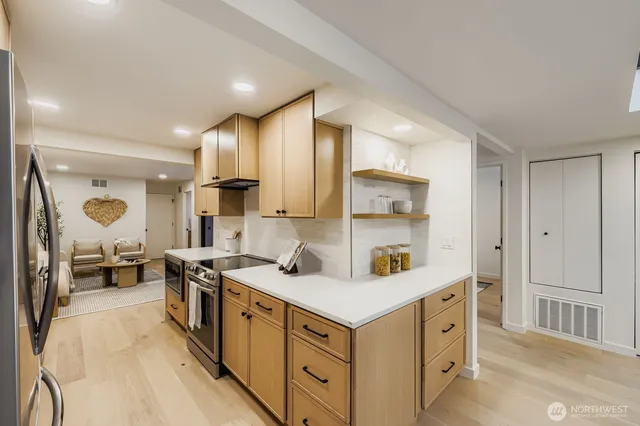a kitchen with stainless steel appliances a sink stove and cabinets