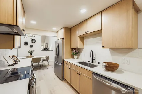a kitchen with a sink and chairs