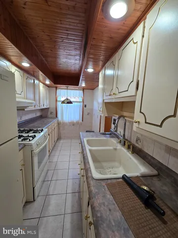 a kitchen with a sink a counter and appliances