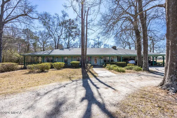 a view of a house with a yard covered in snow
