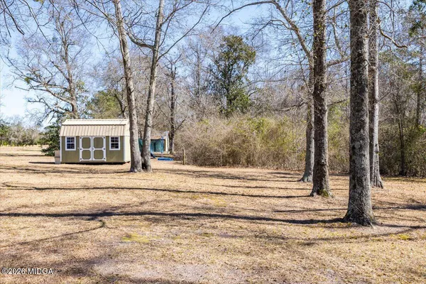 a living room with furniture a flat screen tv and a large window