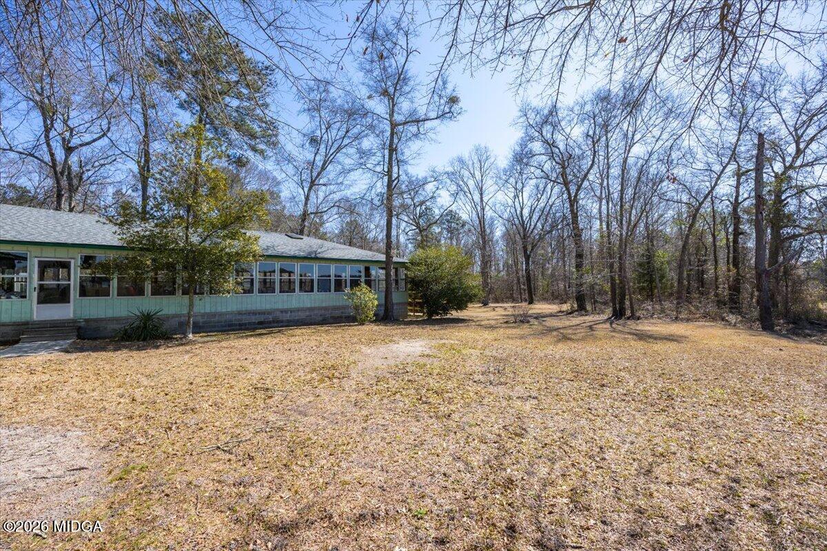 146 Mooring Road Hawkinsville, GA 31036 - Photo 16 of 64 a house with trees in front of it