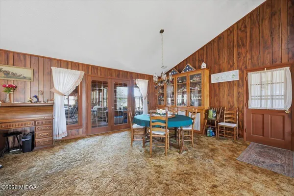 a kitchen with sink cabinets dining table and chairs