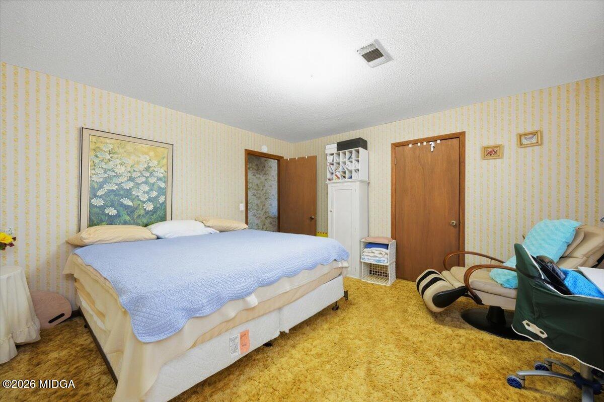 146 Mooring Road Hawkinsville, GA 31036 - Photo 27 of 64 a bedroom with a bed and wooden floor