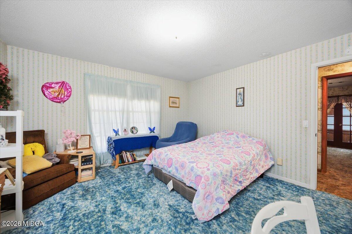 146 Mooring Road Hawkinsville, GA 31036 - Photo 29 of 64 a bedroom with a bed and a couch