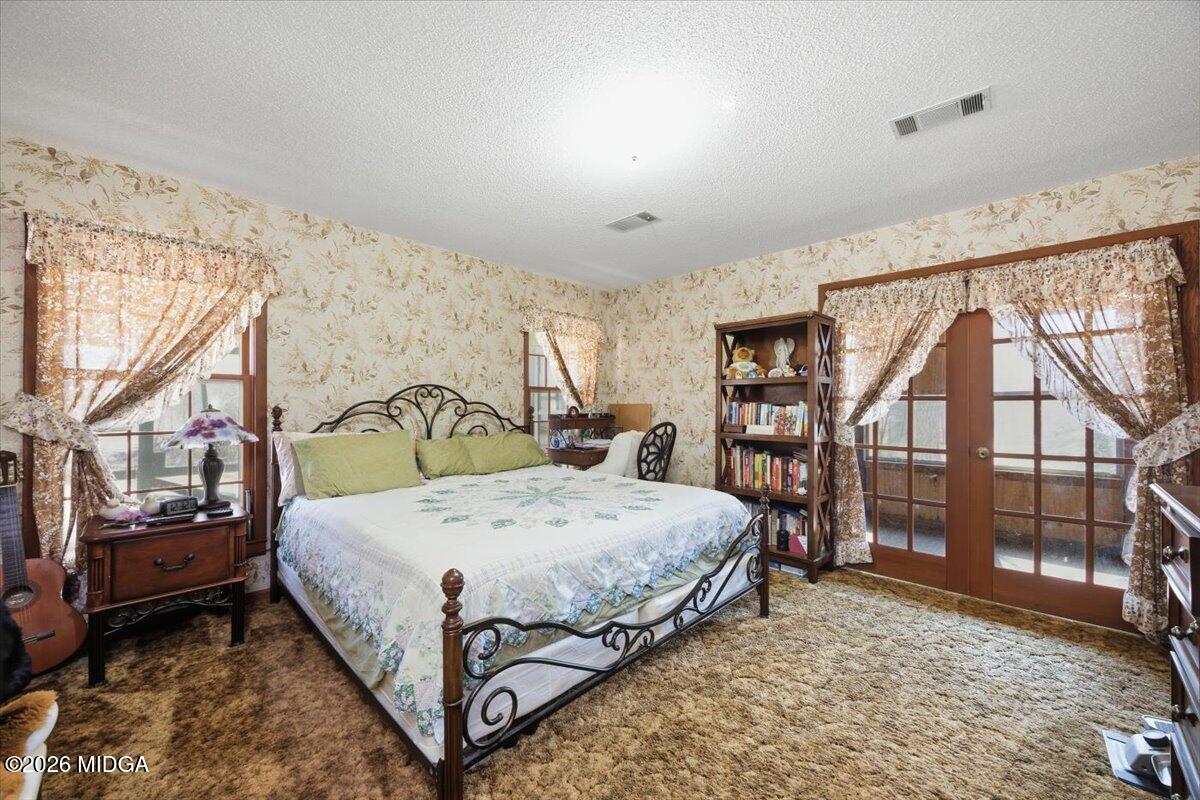 146 Mooring Road Hawkinsville, GA 31036 - Photo 31 of 64 a bed sitting in a room next to a window