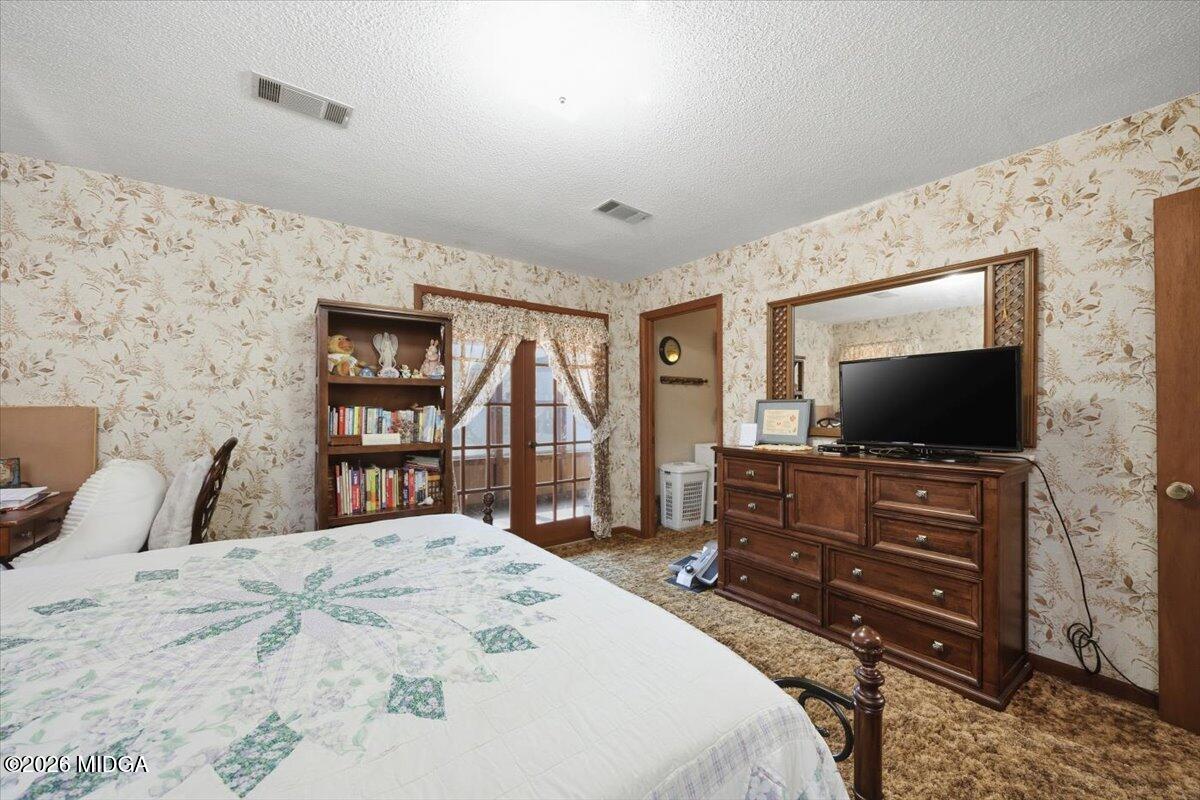 146 Mooring Road Hawkinsville, GA 31036 - Photo 36 of 64 a bedroom with a bed and a flat screen tv