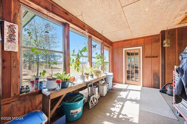 a hallway with furniture and a large window